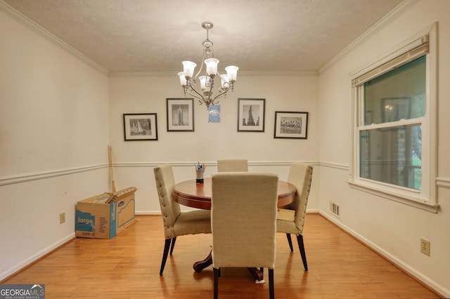2368 Ellis Ct, Snellville, GA 30078 - dining room featuring a chandelier, crown molding, wood finished floors, and a textured ceiling