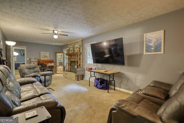 2368 Ellis Ct, Snellville, GA 30078 - carpeted living area featuring a ceiling fan, a fireplace, and a textured ceiling