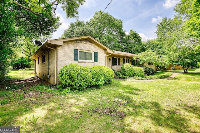 2368 Ellis Ct, Snellville, GA 30078 - view of front of home with brick siding, a front yard, and covered porch