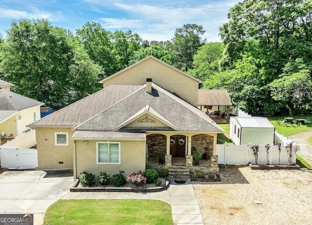 11 Main St, Newnan, GA 30263 - view of front of home with a gate, covered porch, a shingled roof, fence, and stucco siding