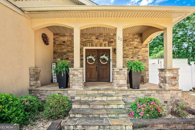 11 Main St, Newnan, GA 30263 - doorway to property with a porch, stone siding, and stucco siding