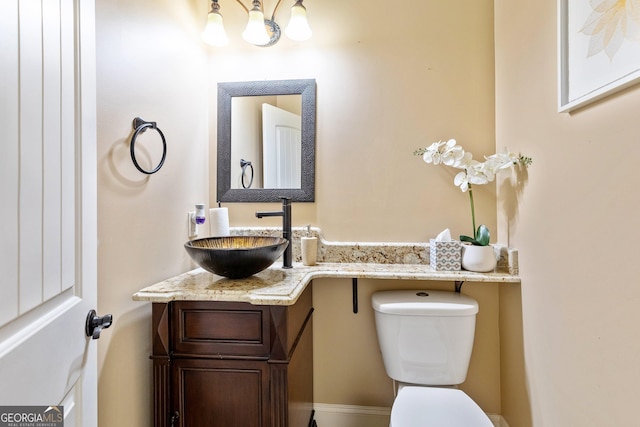 11 Main St, Newnan, GA 30263 - half bath featuring toilet, vanity, and a chandelier