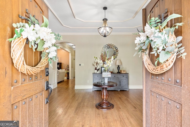 11 Main St, Newnan, GA 30263 - foyer with arched walkways, a tray ceiling, wood finished floors, baseboards, and ornamental molding