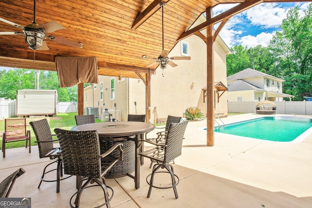 11 Main St, Newnan, GA 30263 - view of swimming pool featuring ceiling fan, a fenced backyard, a patio, and central AC unit