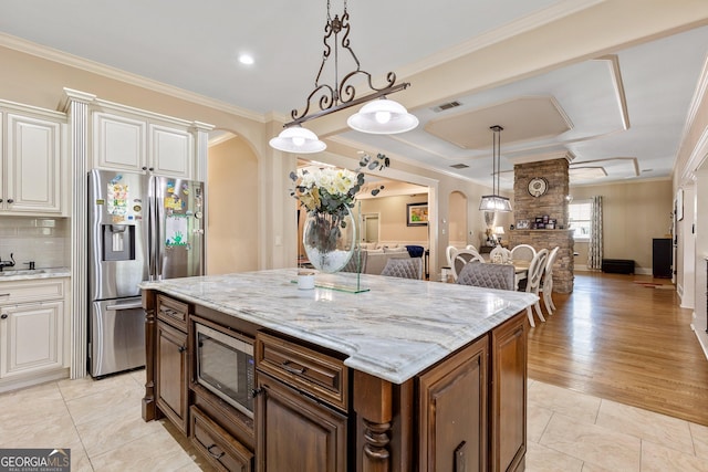 11 Main St, Newnan, GA 30263 - kitchen featuring arched walkways, appliances with stainless steel finishes, open floor plan, light stone countertops, and ornamental molding