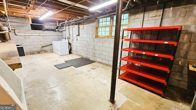 basement with washer / dryer and concrete block wall