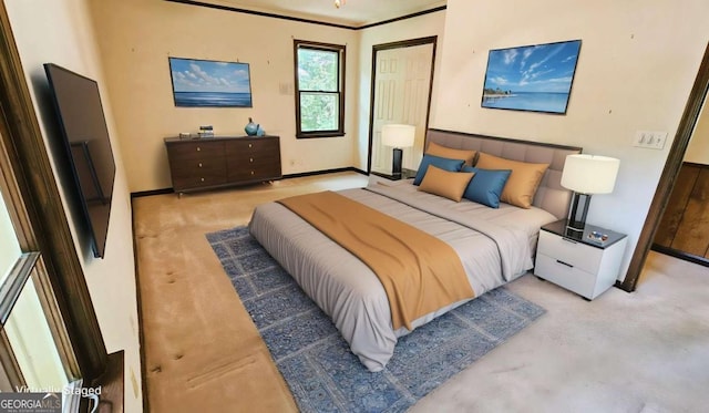 bedroom with carpet floors, baseboards, and crown molding