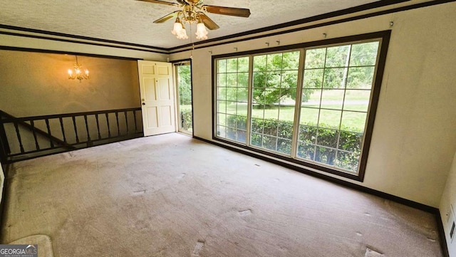 carpeted empty room with healthy amount of natural light, a textured ceiling, baseboards, ornamental molding, and a ceiling fan
