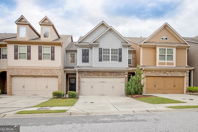 view of property featuring a garage and driveway