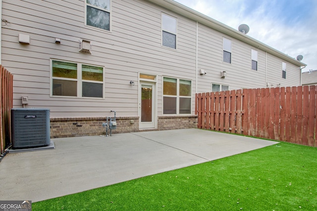 back of property with cooling unit and a patio