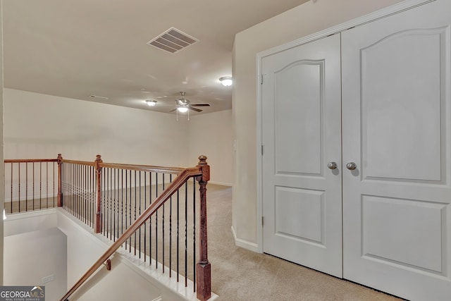 staircase with carpet, ceiling fan, and baseboards