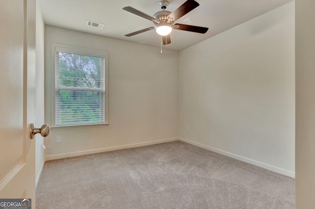 spare room with carpet flooring, a ceiling fan, and baseboards