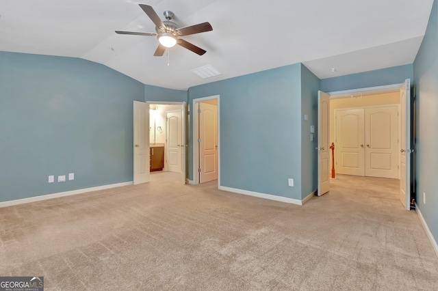 unfurnished bedroom featuring vaulted ceiling, baseboards, carpet flooring, and a ceiling fan