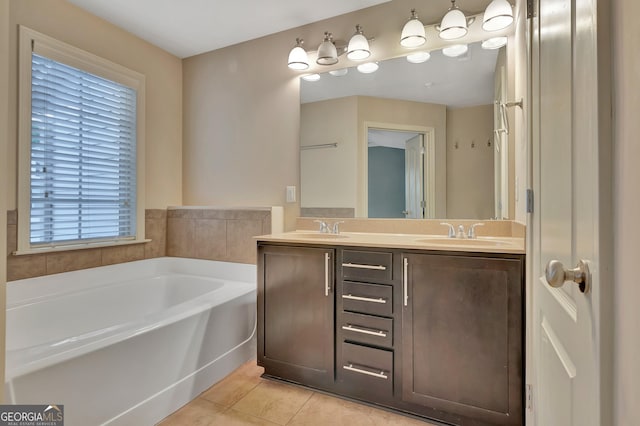 full bathroom featuring a bath, healthy amount of natural light, tile patterned floors, and double vanity