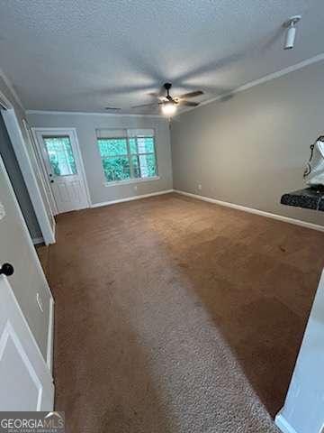 146-148 Arnold Rd, Gray, GA 31032 - unfurnished living room featuring ceiling fan, a textured ceiling, carpet flooring, and baseboards