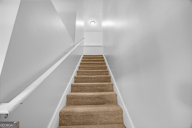 staircase with carpet floors and baseboards