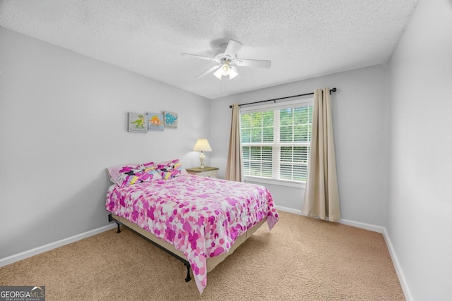 bedroom featuring carpet flooring, a textured ceiling, baseboards, and ceiling fan