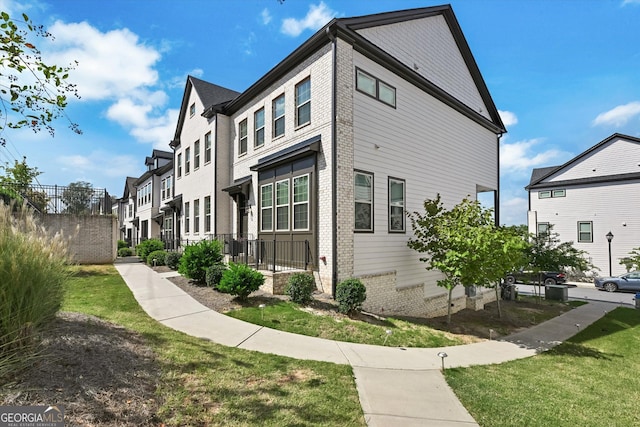 view of side of home featuring brick siding and a residential view