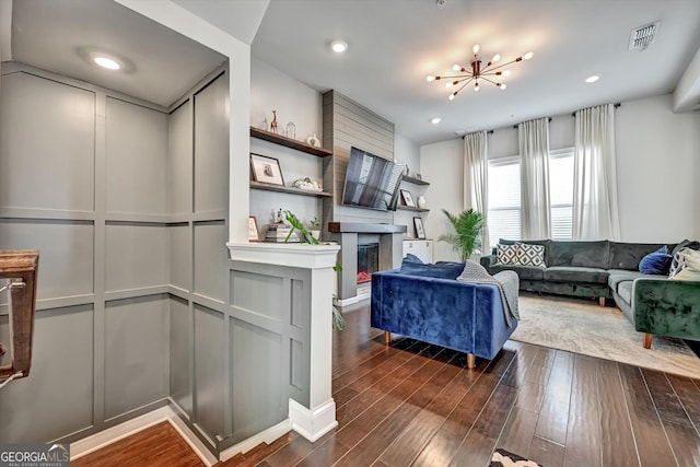 living room featuring dark wood finished floors and a glass covered fireplace