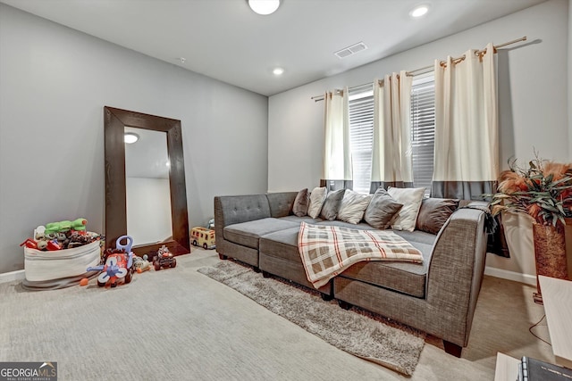carpeted living area featuring baseboards and recessed lighting