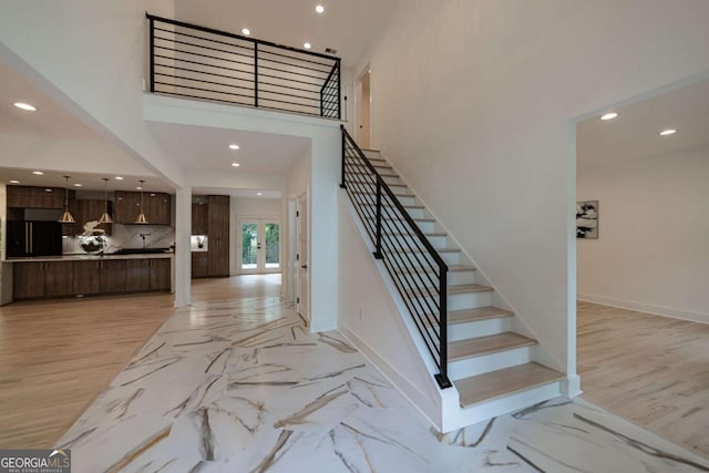 4 Bentley Trace Mnr, Atlanta, GA 30327 - staircase featuring recessed lighting, a high ceiling, and french doors