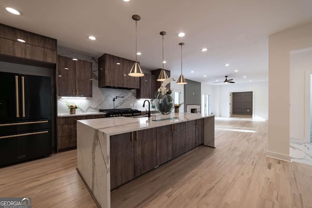 4 Bentley Trace Mnr, Atlanta, GA 30327 - kitchen featuring freestanding refrigerator, modern cabinets, recessed lighting, a large island with sink, and light wood-type flooring