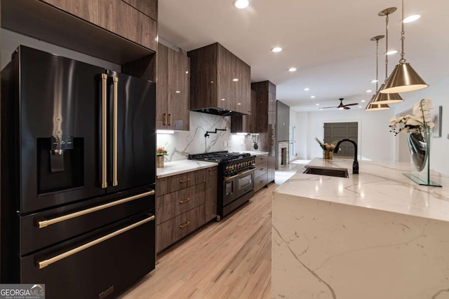 4 Bentley Trace Mnr, Atlanta, GA 30327 - kitchen featuring black appliances, modern cabinets, ceiling fan, light wood-type flooring, and hanging light fixtures