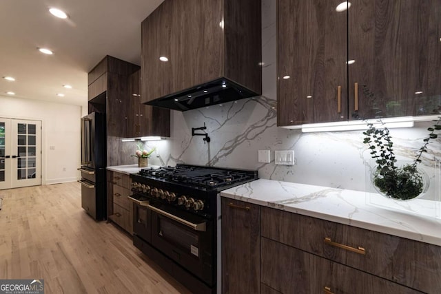 4 Bentley Trace Mnr, Atlanta, GA 30327 - kitchen featuring black appliances, decorative backsplash, modern cabinets, wall chimney range hood, and recessed lighting