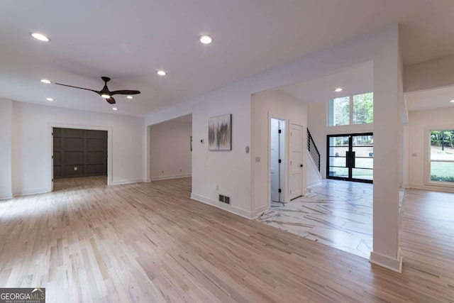 4 Bentley Trace Mnr, Atlanta, GA 30327 - unfurnished living room featuring a ceiling fan, light wood-style floors, stairs, and recessed lighting