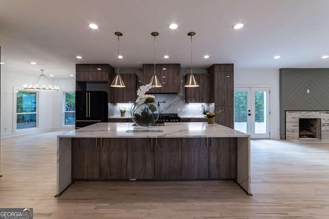 4 Bentley Trace Mnr, Atlanta, GA 30327 - kitchen featuring freestanding refrigerator, light wood finished floors, modern cabinets, recessed lighting, and a spacious island