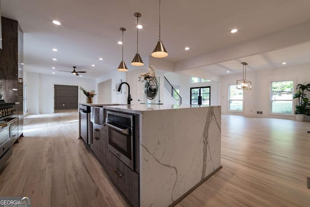 4 Bentley Trace Mnr, Atlanta, GA 30327 - kitchen featuring open floor plan, light wood finished floors, a large island, pendant lighting, and recessed lighting