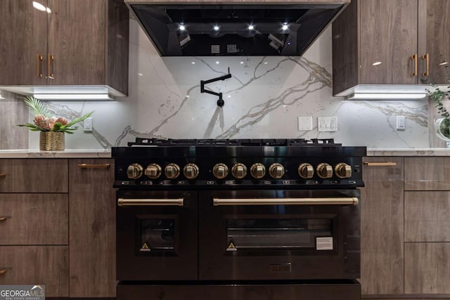 4 Bentley Trace Mnr, Atlanta, GA 30327 - kitchen featuring range with two ovens, modern cabinets, exhaust hood, and decorative backsplash