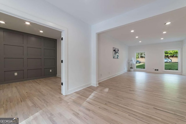 4 Bentley Trace Mnr, Atlanta, GA 30327 - empty room featuring light wood finished floors, a decorative wall, and recessed lighting