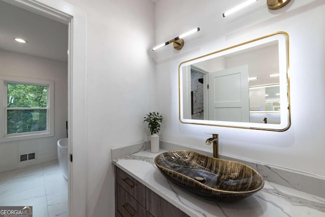 4 Bentley Trace Mnr, Atlanta, GA 30327 - bathroom with marble look tiles, vanity, and recessed lighting