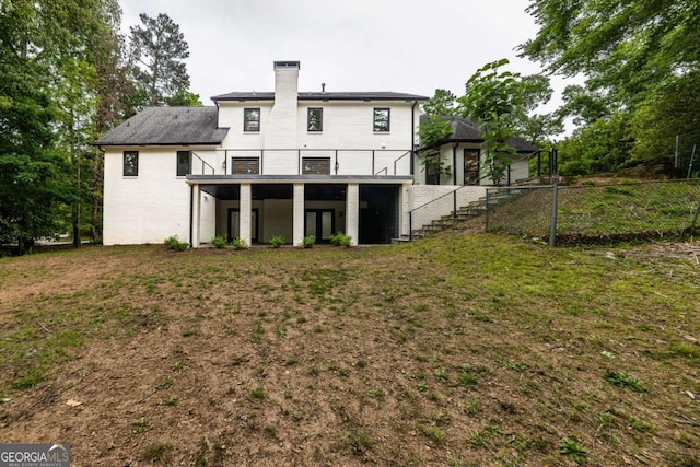 4 Bentley Trace Mnr, Atlanta, GA 30327 - rear view of property featuring stairs, a chimney, and brick siding