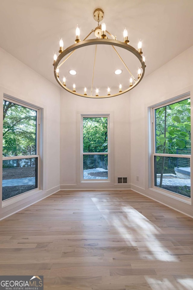 4 Bentley Trace Mnr, Atlanta, GA 30327 - unfurnished room featuring a chandelier, healthy amount of natural light, wood finished floors, and recessed lighting