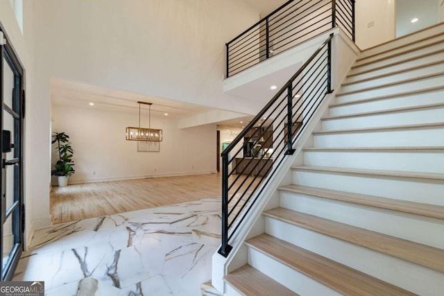 4 Bentley Trace Mnr, Atlanta, GA 30327 - stairway with a towering ceiling, a chandelier, marble tiled floors, and recessed lighting