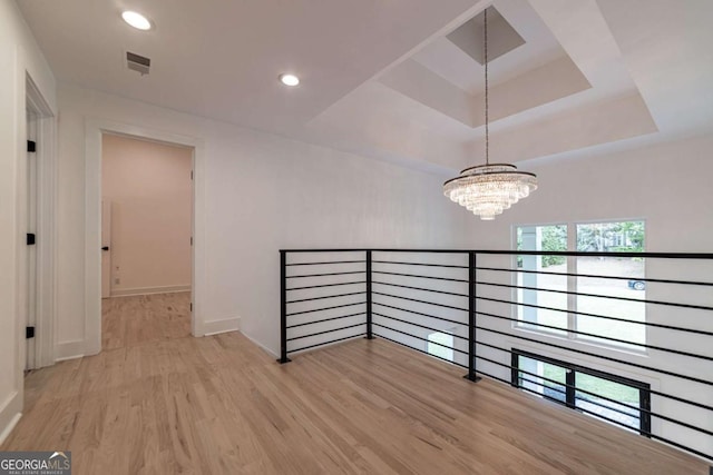 4 Bentley Trace Mnr, Atlanta, GA 30327 - hall featuring a chandelier, wood finished floors, a raised ceiling, recessed lighting, and an upstairs landing