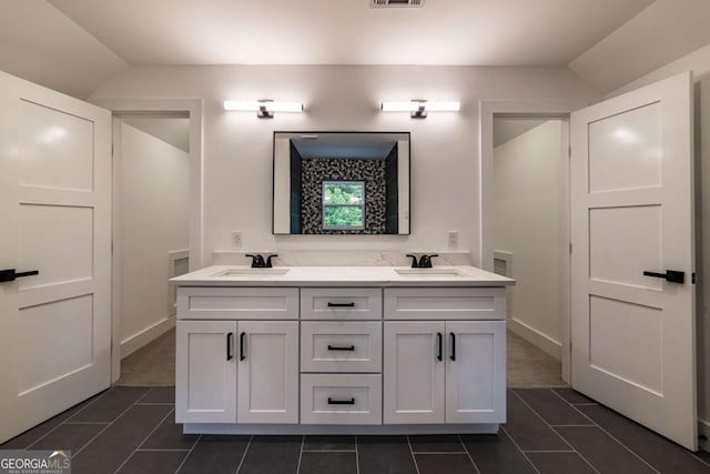 4 Bentley Trace Mnr, Atlanta, GA 30327 - bathroom with tile patterned floors, double vanity, and lofted ceiling