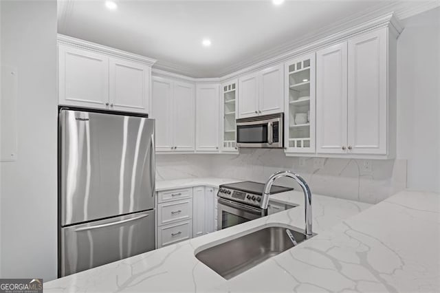 2499 Peachtree Rd NE Unit 503, Atlanta, GA 30305 - kitchen featuring stainless steel appliances, glass insert cabinets, white cabinetry, light stone counters, and recessed lighting