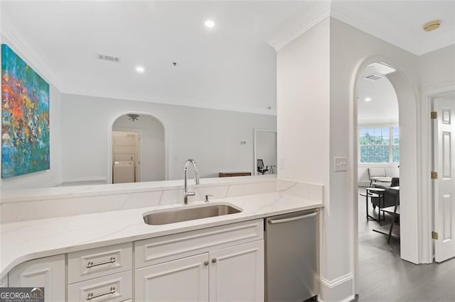 2499 Peachtree Rd NE Unit 503, Atlanta, GA 30305 - kitchen featuring dishwasher, a sink, arched walkways, light stone counters, and white cabinetry
