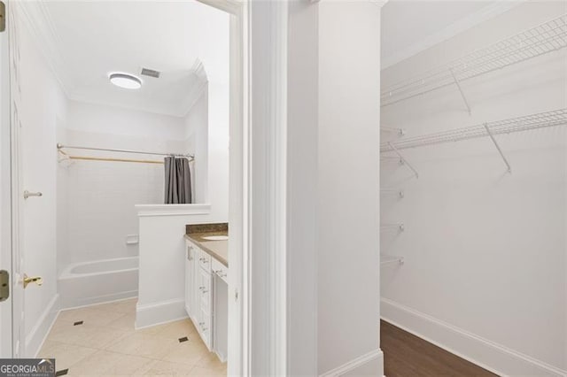 2499 Peachtree Rd NE Unit 503, Atlanta, GA 30305 - full bathroom with ornamental molding, vanity, a spacious closet, shower / bathtub combination, and baseboards