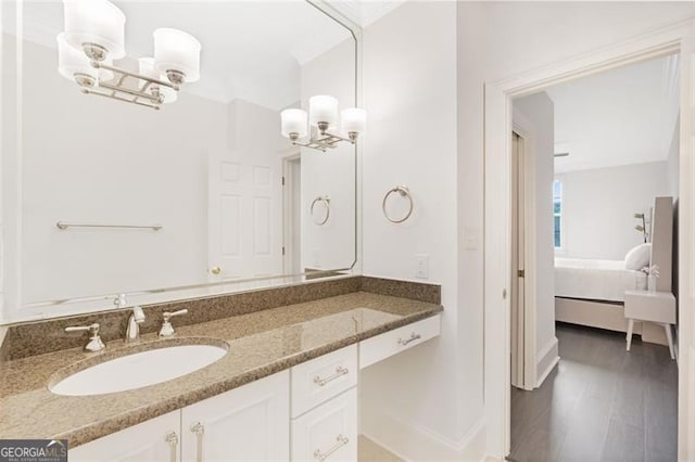 2499 Peachtree Rd NE Unit 503, Atlanta, GA 30305 - bathroom featuring a chandelier, vanity, connected bathroom, and baseboards