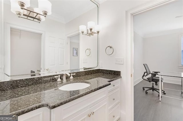 2499 Peachtree Rd NE Unit 503, Atlanta, GA 30305 - bathroom with crown molding, vanity, a chandelier, and baseboards