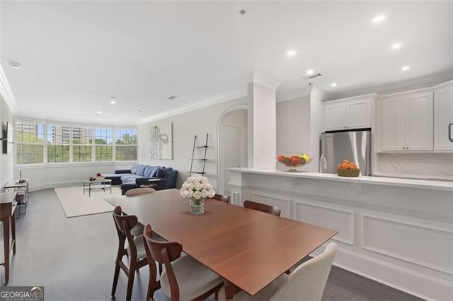 2499 Peachtree Rd NE Unit 503, Atlanta, GA 30305 - dining area featuring ornamental molding, recessed lighting, arched walkways, and dark wood finished floors