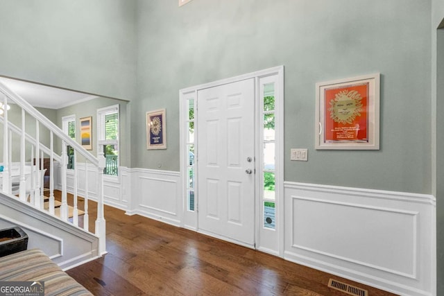 4027 Mount Vernon Dr, Woodstock, GA 30189 - entryway featuring wood finished floors, stairs, a wainscoted wall, a decorative wall, and ornamental molding