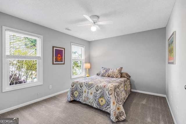 4027 Mount Vernon Dr, Woodstock, GA 30189 - carpeted bedroom with a textured ceiling, baseboards, and a ceiling fan