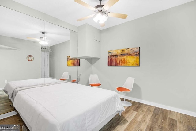 4027 Mount Vernon Dr, Woodstock, GA 30189 - bedroom featuring wood finished floors, a ceiling fan, and baseboards