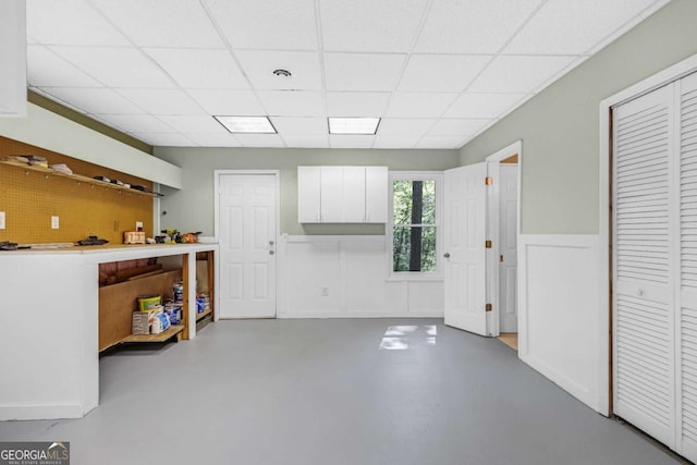 4027 Mount Vernon Dr, Woodstock, GA 30189 - miscellaneous room featuring a drop ceiling, concrete floors, and a wainscoted wall