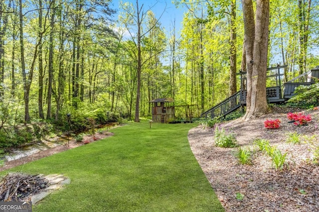 4027 Mount Vernon Dr, Woodstock, GA 30189 - view of grassy yard featuring stairs and a wooden deck